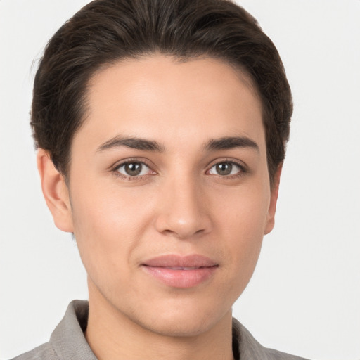 Joyful white young-adult female with short  brown hair and brown eyes