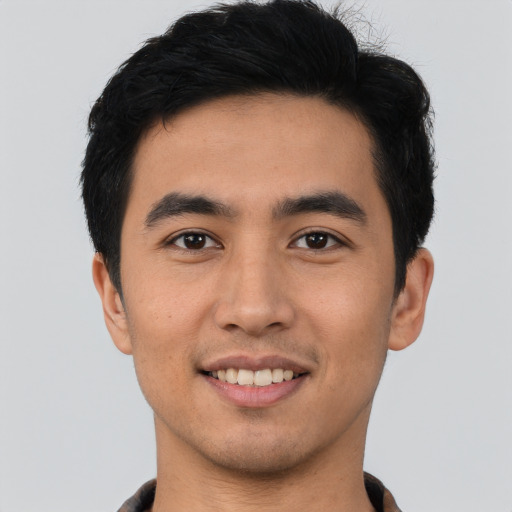 Joyful asian young-adult male with short  black hair and brown eyes