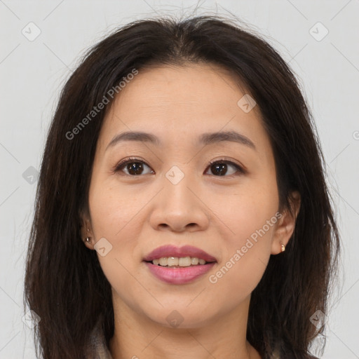 Joyful asian young-adult female with long  brown hair and brown eyes