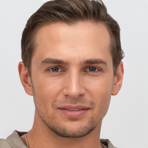 Joyful white young-adult male with short  brown hair and brown eyes