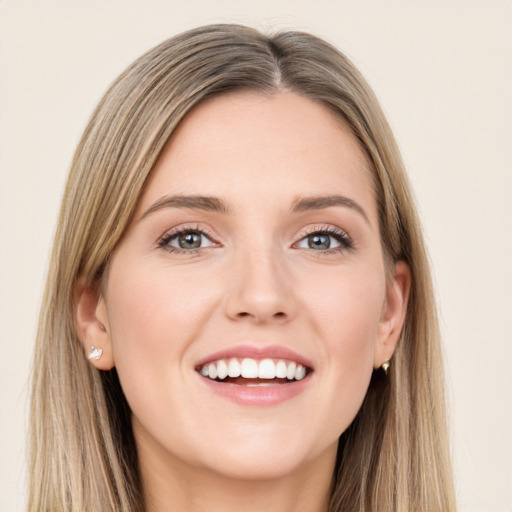 Joyful white young-adult female with long  brown hair and green eyes