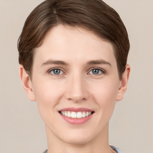 Joyful white young-adult female with short  brown hair and grey eyes