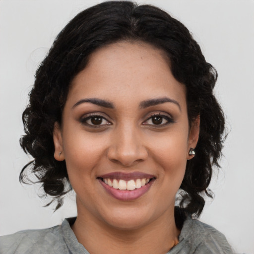 Joyful latino young-adult female with long  black hair and brown eyes