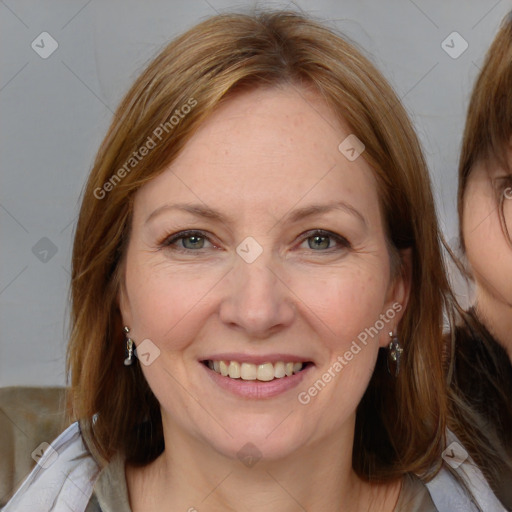 Joyful white adult female with medium  brown hair and blue eyes