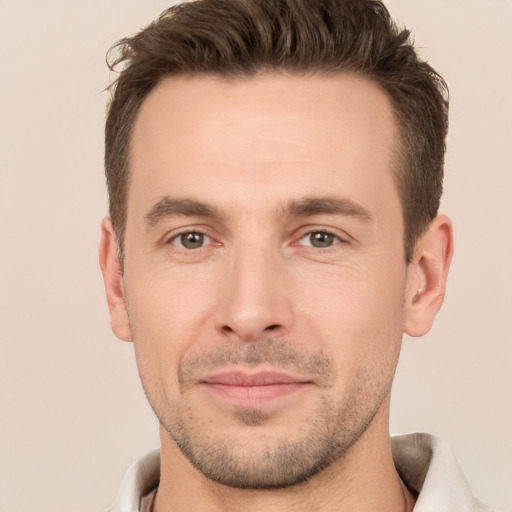 Joyful white young-adult male with short  brown hair and brown eyes