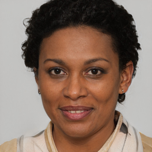 Joyful black adult female with short  brown hair and brown eyes