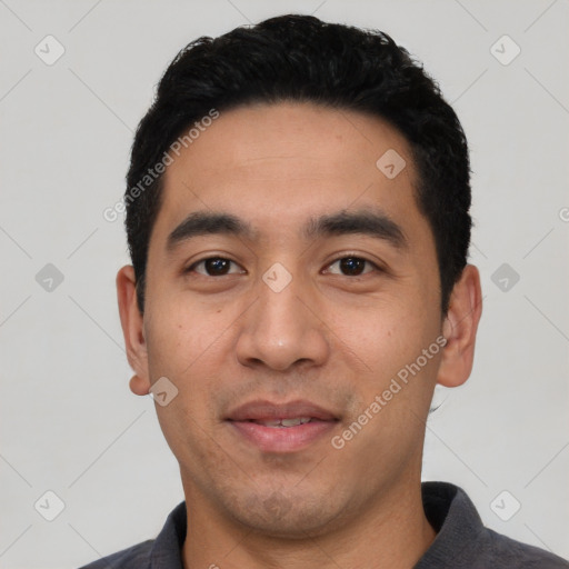 Joyful latino young-adult male with short  black hair and brown eyes