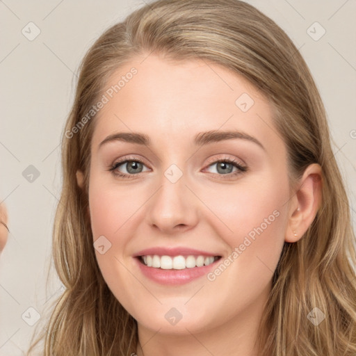 Joyful white young-adult female with long  brown hair and blue eyes