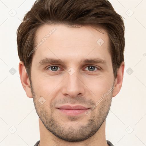 Joyful white young-adult male with short  brown hair and grey eyes