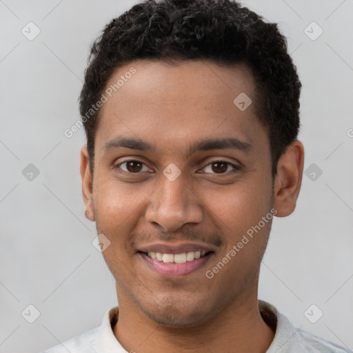 Joyful latino young-adult male with short  brown hair and brown eyes