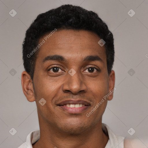 Joyful black young-adult male with short  black hair and brown eyes