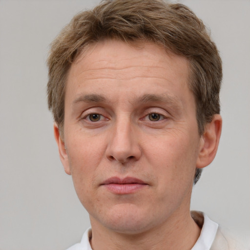 Joyful white adult male with short  brown hair and grey eyes