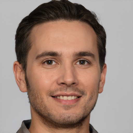 Joyful white young-adult male with short  brown hair and brown eyes