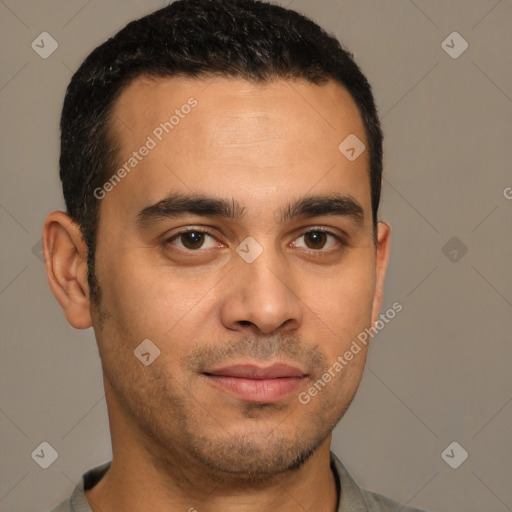 Joyful latino young-adult male with short  brown hair and brown eyes