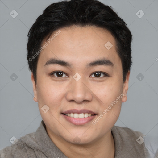 Joyful asian young-adult male with short  black hair and brown eyes