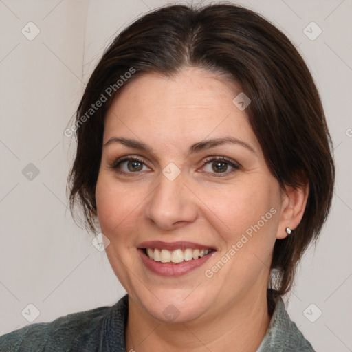 Joyful white adult female with medium  brown hair and brown eyes