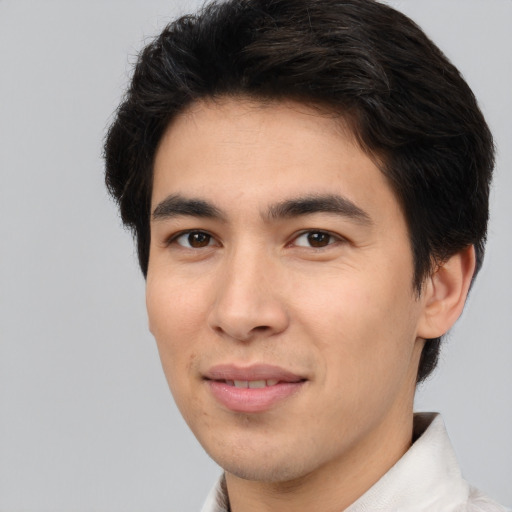 Joyful asian young-adult male with short  brown hair and brown eyes