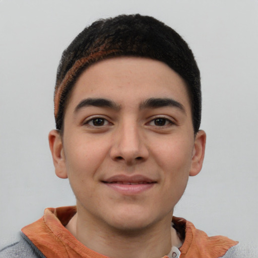 Joyful latino young-adult male with short  brown hair and brown eyes