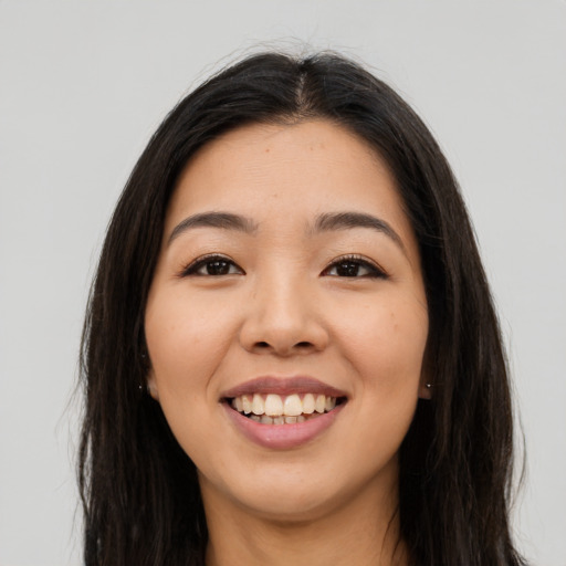 Joyful asian young-adult female with long  brown hair and brown eyes