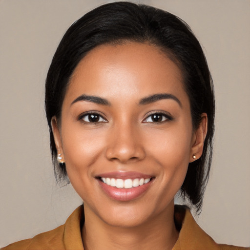 Joyful latino young-adult female with medium  black hair and brown eyes