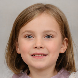 Joyful white child female with medium  brown hair and blue eyes