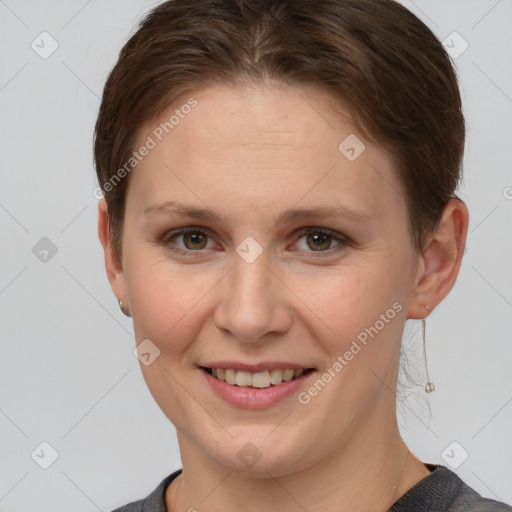 Joyful white young-adult female with short  brown hair and grey eyes