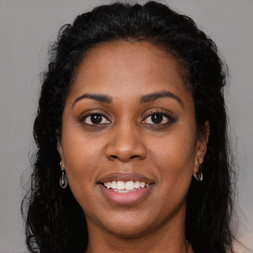 Joyful latino young-adult female with long  black hair and brown eyes