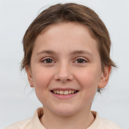 Joyful white child female with medium  brown hair and brown eyes