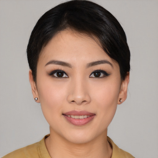 Joyful asian young-adult female with short  black hair and brown eyes
