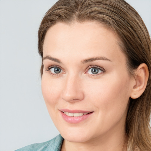 Joyful white young-adult female with medium  brown hair and blue eyes