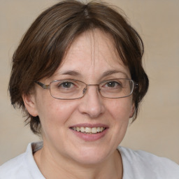 Joyful white adult female with medium  brown hair and blue eyes