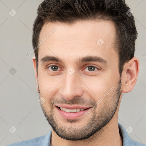 Joyful white young-adult male with short  brown hair and brown eyes