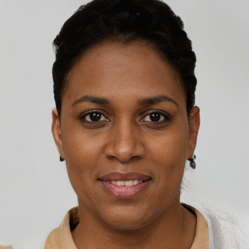 Joyful black young-adult female with short  brown hair and brown eyes