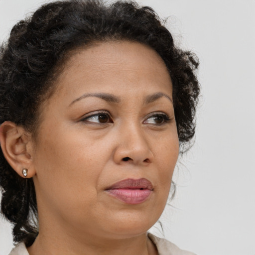 Neutral latino adult female with medium  brown hair and brown eyes