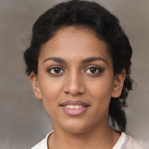 Joyful black young-adult female with short  brown hair and brown eyes