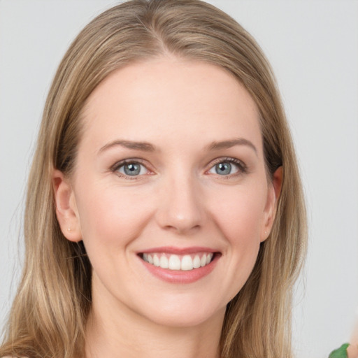 Joyful white young-adult female with long  brown hair and grey eyes