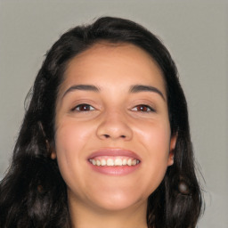 Joyful latino young-adult female with long  black hair and brown eyes