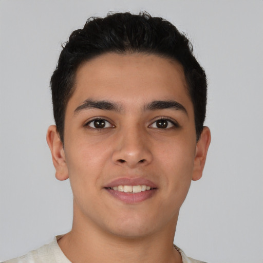 Joyful latino young-adult male with short  brown hair and brown eyes