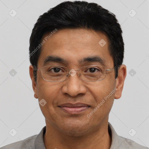 Joyful asian adult male with short  black hair and brown eyes