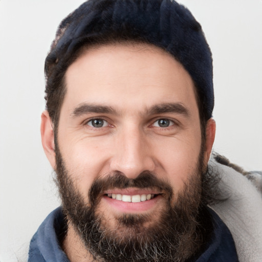 Joyful white young-adult male with short  black hair and brown eyes