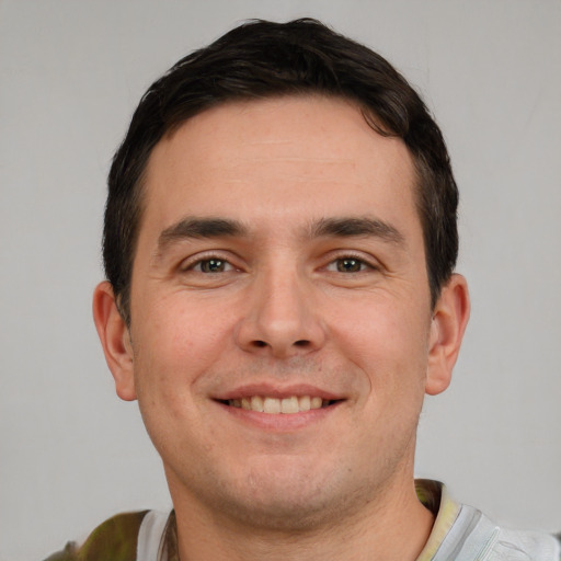 Joyful white young-adult male with short  brown hair and brown eyes