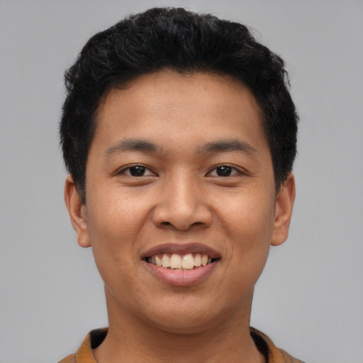 Joyful asian young-adult male with short  black hair and brown eyes