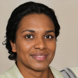 Joyful black adult female with short  brown hair and brown eyes