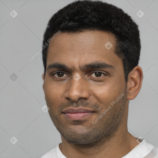 Joyful black young-adult male with short  black hair and brown eyes