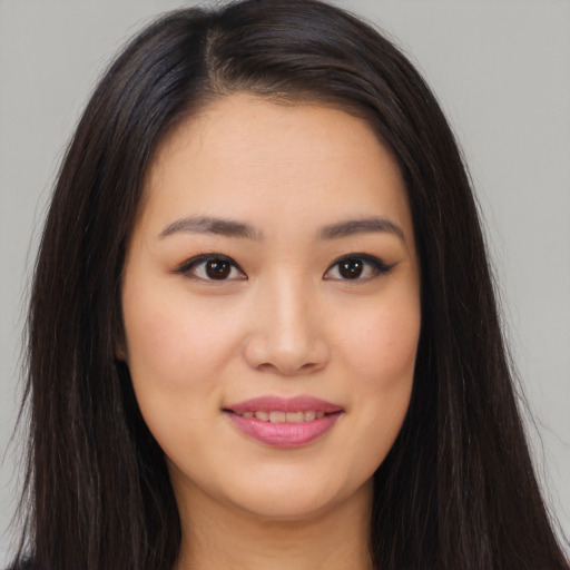 Joyful asian young-adult female with long  brown hair and brown eyes