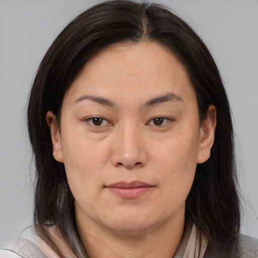Joyful asian adult female with medium  brown hair and brown eyes