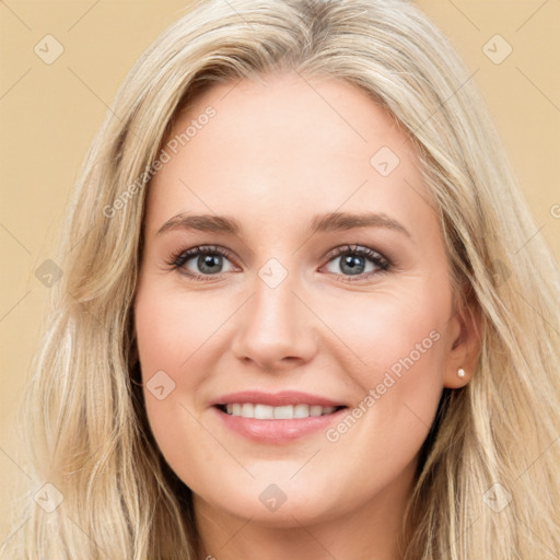 Joyful white young-adult female with long  brown hair and blue eyes