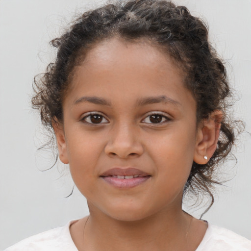 Joyful latino child female with medium  brown hair and brown eyes