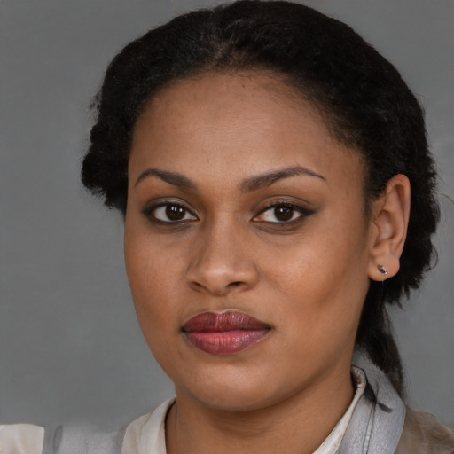 Joyful black young-adult female with short  brown hair and brown eyes