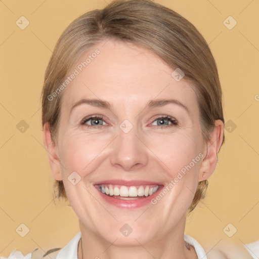 Joyful white adult female with medium  brown hair and blue eyes